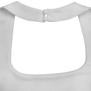 Close-up of dual white resin button closure on a backless white halter jumpsuit