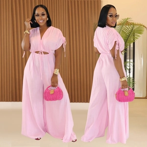 Detail of light pink wide-leg jumpsuit with v-neck and waist cutout design