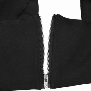 Close-up of a silver metal zipper detail on high-quality black women's trousers fabric