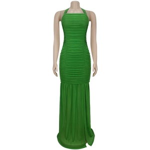 Detail view of grass green ruched mesh dress with side slit and slim fit silhouette