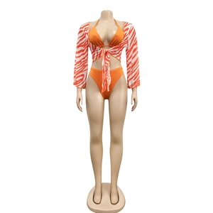Three-piece vibrant orange bikini set with zebra print mesh cover-up for beachwear