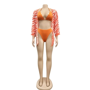 Detailed view of women's orange bikini top with matching zebra print long sleeve cover-up