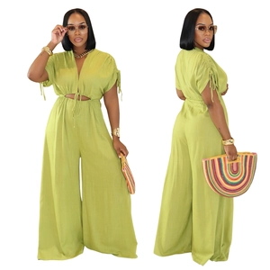 Detail of green V-neck jumpsuit with waist cutout and drawstring tie on the front and back