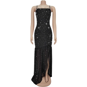 Detail of black evening dress with sparkling rhinestones and sheer mesh slit hem