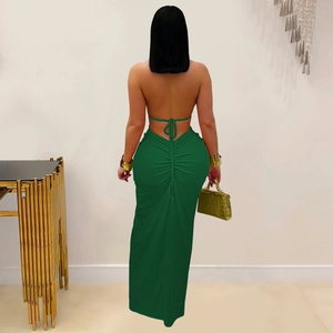 Detail of emerald green backless dress featuring ruched design and bodycon fit