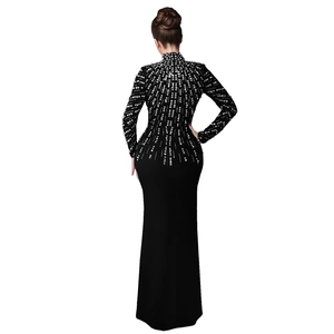 Close-up of the back detail on black long-sleeve dress with silver rhinestones and beads