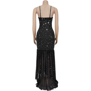 Detail of a black fishtail evening dress featuring sparkling rhinestones and open back design