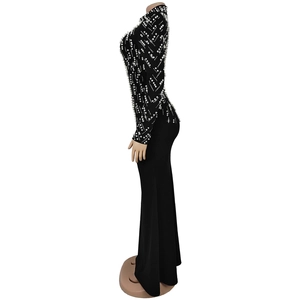 Detailed view of luxury black long sleeve dress with white beads and rhinestone embellishments