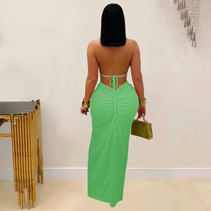 Detail of emerald green backless dress with lace-up drawstring and ruched back design