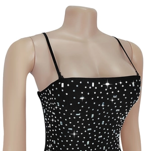 Detailed close-up of sparkling rhinestones on a black sleeveless party dress