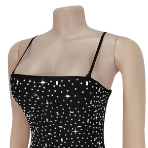 Detailed view of black rhinestone-studded dress with sparkling crystal embellishments