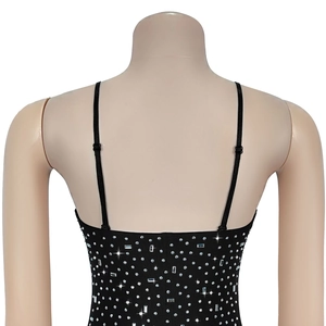 Detail of adjustable straps and gradient rhinestones on a black evening dress back