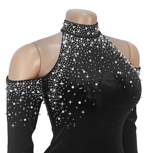 Détail de la robe en velours noir avec perles élégantes et ornements en strass brillants