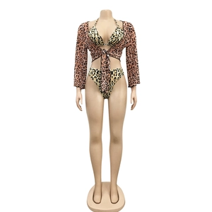 Detailed view of three-piece leopard print bikini set with long sleeve mesh cover-up
