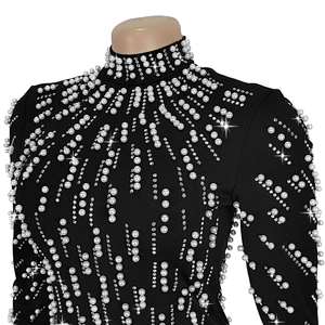 Detail of black high-neck dress with intricate pearl beading and rhinestone embellishments