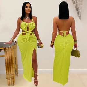 Detail of neon green halter maxi dress with knit texture and waist cutout design