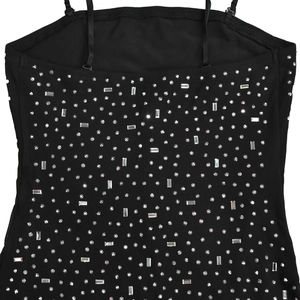 Close-up of black mesh dress featuring silver rhinestones and crystal embellishments