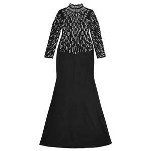 Detail of elegant black dress showing intricate white pearl beadwork on sleeves and chest