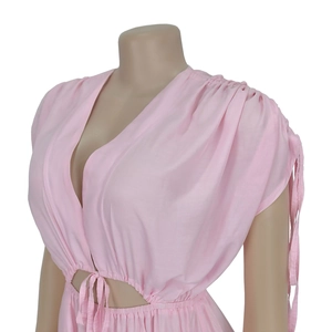 Detail of pink V-neck jumpsuit featuring side cut-outs and drawstring waist accents