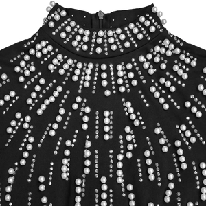 Detail of high neck black dress featuring gradient pearls, rhinestones and back zipper
