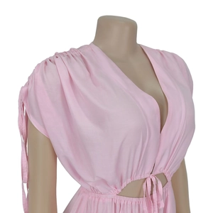 Close-up of deep V-neckline with drawstring detail on a pink wide-leg jumpsuit