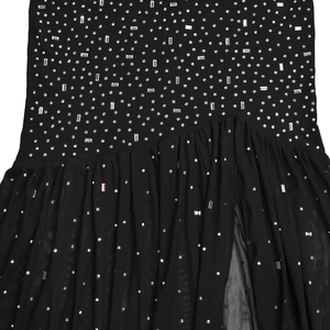 Detailed view of black rhinestones and pleated mesh fabric on a sexy split dress