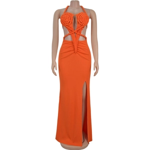 Detail of vibrant orange halter maxi dress with knit floral bust and waist cut-out