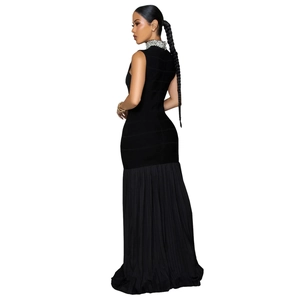 Detail of elegant black slim-fit dress with pearl-embellished high neck and pleated skirt