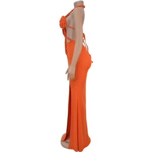 Detail view of the orange knit dress featuring 3D floral weave and sexy side cut-outs