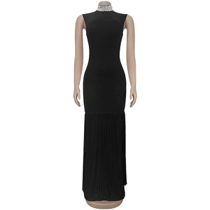 Detail of high neck with dense pearl embellishments on a black slim pleated dress