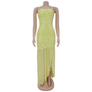 Detail of light yellow dress featuring thin straps and sparkling silver rhinestones