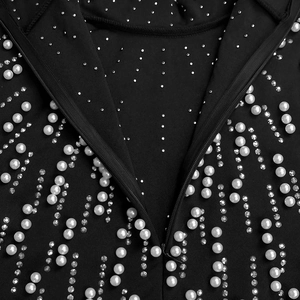 Detail of elegant black dress neckline with white pearls and silver rhinestones by zipper