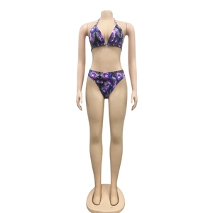 Detail of blue and purple peacock feather print bikini set with halter neck on mannequin