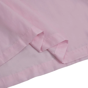 Close-up detail of soft pink wide-leg jumpsuit showing fine fabric texture and stitching