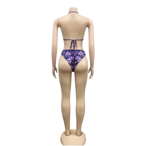 Back view of a purple leopard print bikini set with feather patterns on a mannequin