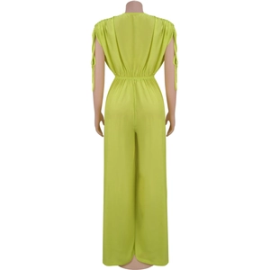 Detail of lime green sleeveless jumpsuit featuring a deep V-back and shoulder tie straps