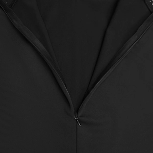 Detail view of the high-quality invisible back zipper on a black slim fit pleated dress
