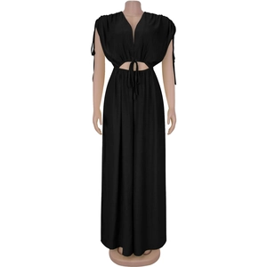 Detail view of black V-neck jumpsuit featuring side cut-outs and lace-up waist detail