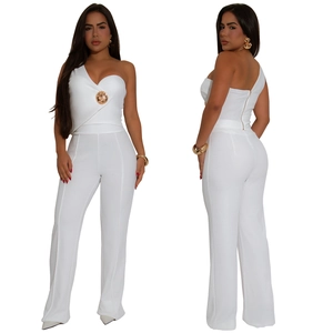 Close-up of white one-shoulder top with gold buckle and matching high waist trousers