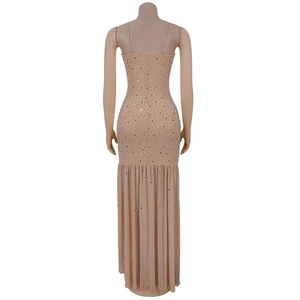 Detail of champagne evening dress featuring silver rhinestones and fish-tail hem