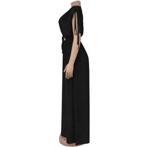 Detail view of black sleeveless jumpsuit with adjustable shoulder straps and tied knots
