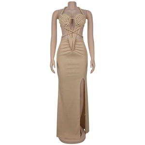 Detail of knit halter dress featuring handmade cord rose applique and waist cut-outs