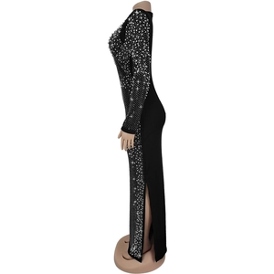 Detail of elegant black long-sleeve dress with sparkling rhinestones and a high side slit