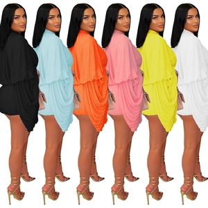 Detailed macro view showing diverse color options of pleated mini dress in vibrant textures