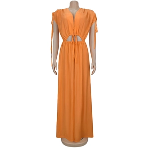 Detailed view of the orange deep V-neck jumpsuit with waist cut-outs and tie-up design