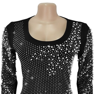 Detail of elegant black knit dress with white pearls and sparkling rhinestones