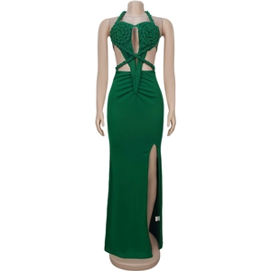 Detail of green knitted halter maxi dress featuring hollow-out floral crochet and side slit
