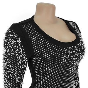 Close-up of elegant black dress with shimmering rhinestones and white pearls detail