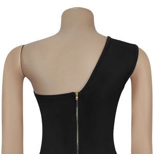 Detail of the golden metal zipper on the back of a black one-shoulder sleeveless top