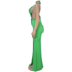 Detail view of bright green halter neck dress with knit texture and side waist cutout